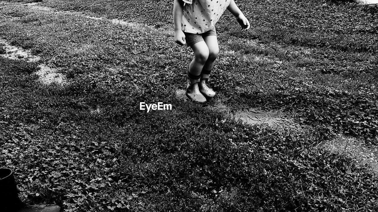 LOW SECTION OF WOMAN WALKING ON LAND