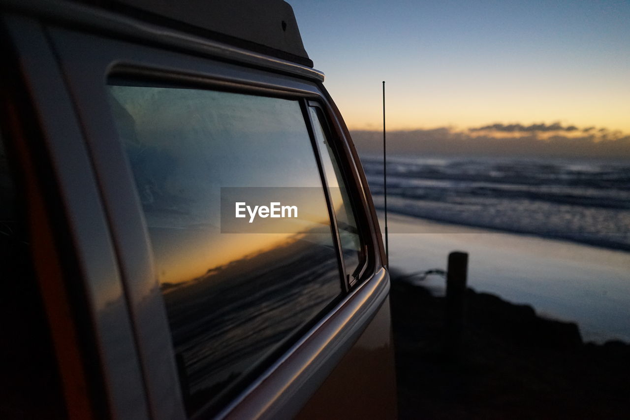 Reflection of seascape on vehicle window
