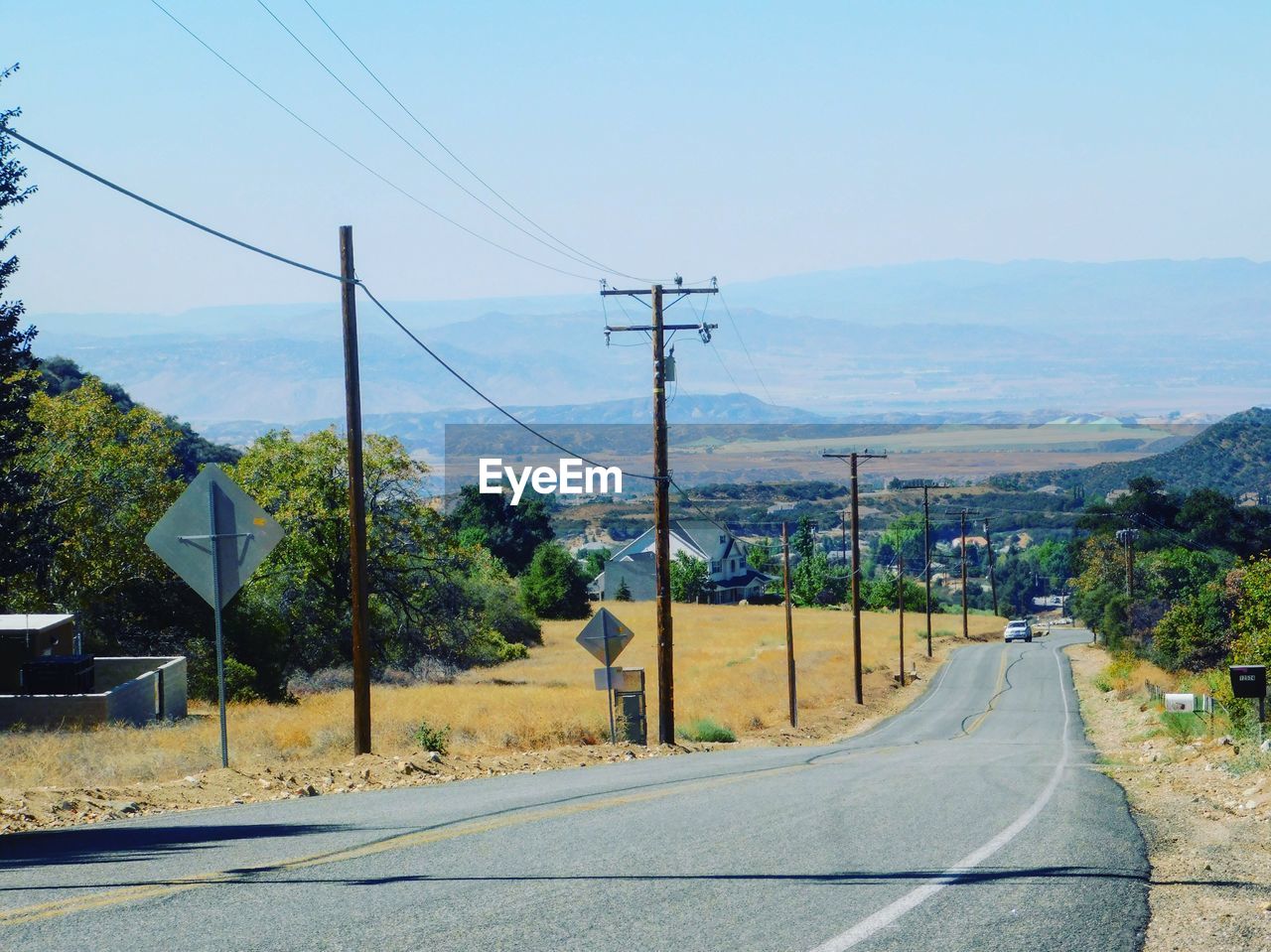 Road by mountain against sky