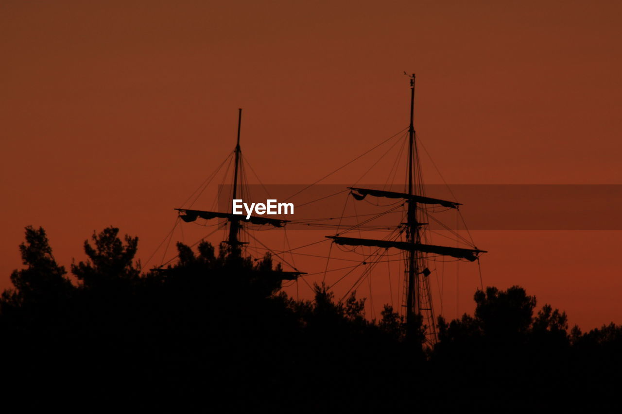 Silhouette of sailboat against sky during sunset