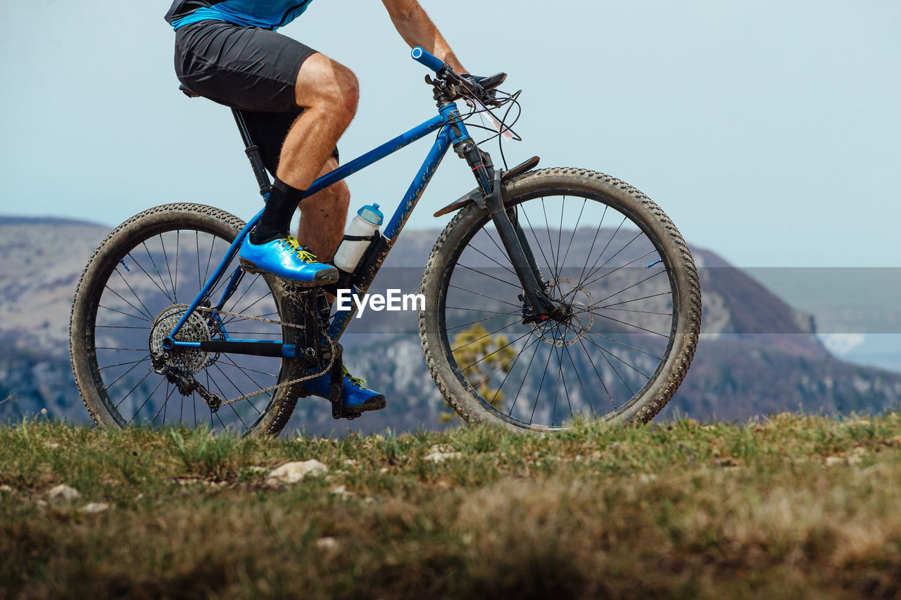 Low section of man riding bicycle