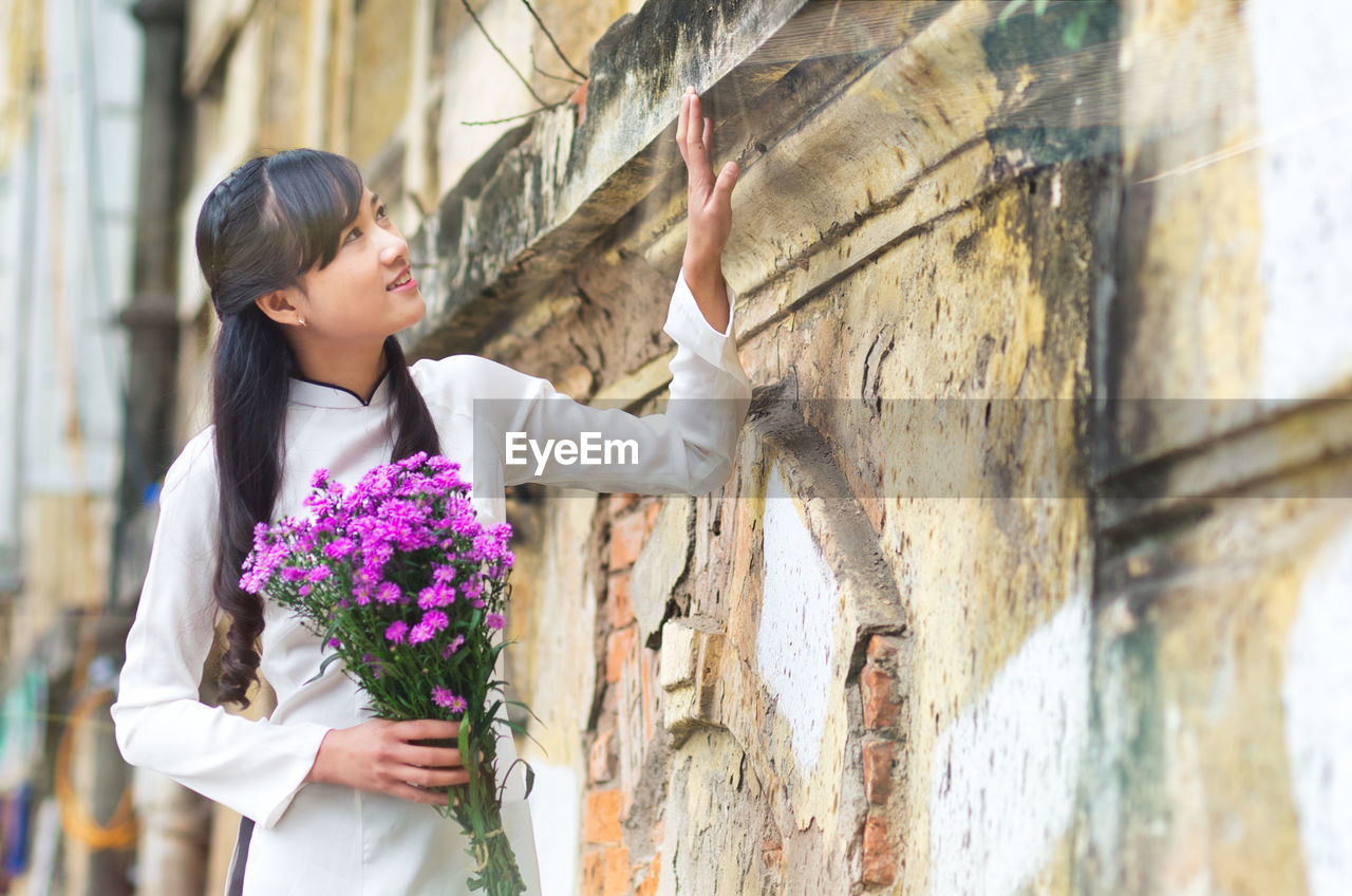 Young vietnamese girl wearing ao dai dress.
