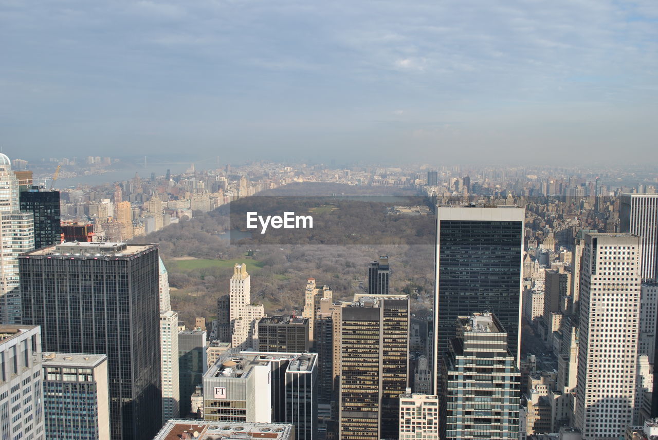 Aerial view of buildings against sky on sunny day