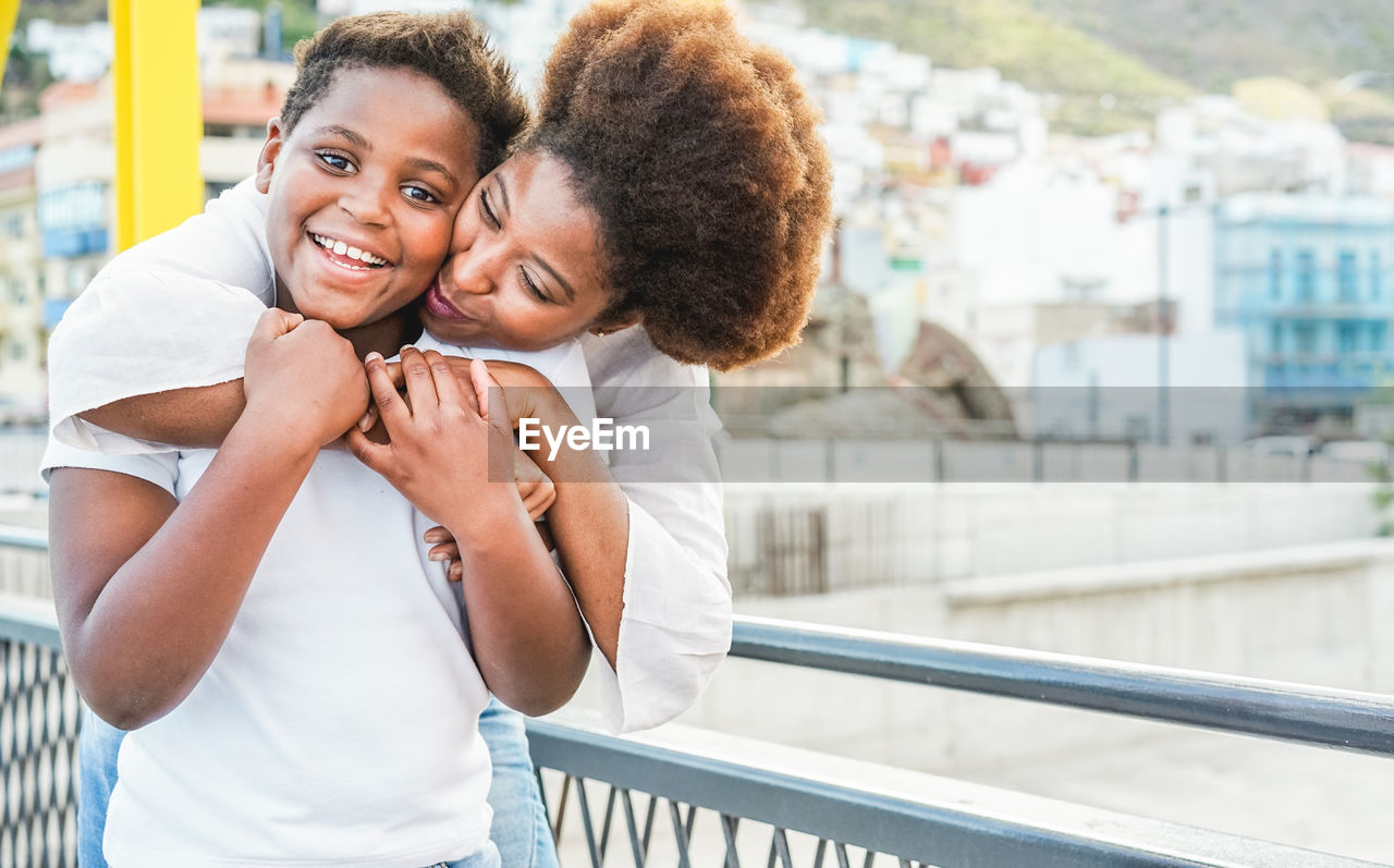 Woman carrying lesbian girlfriend on back in city