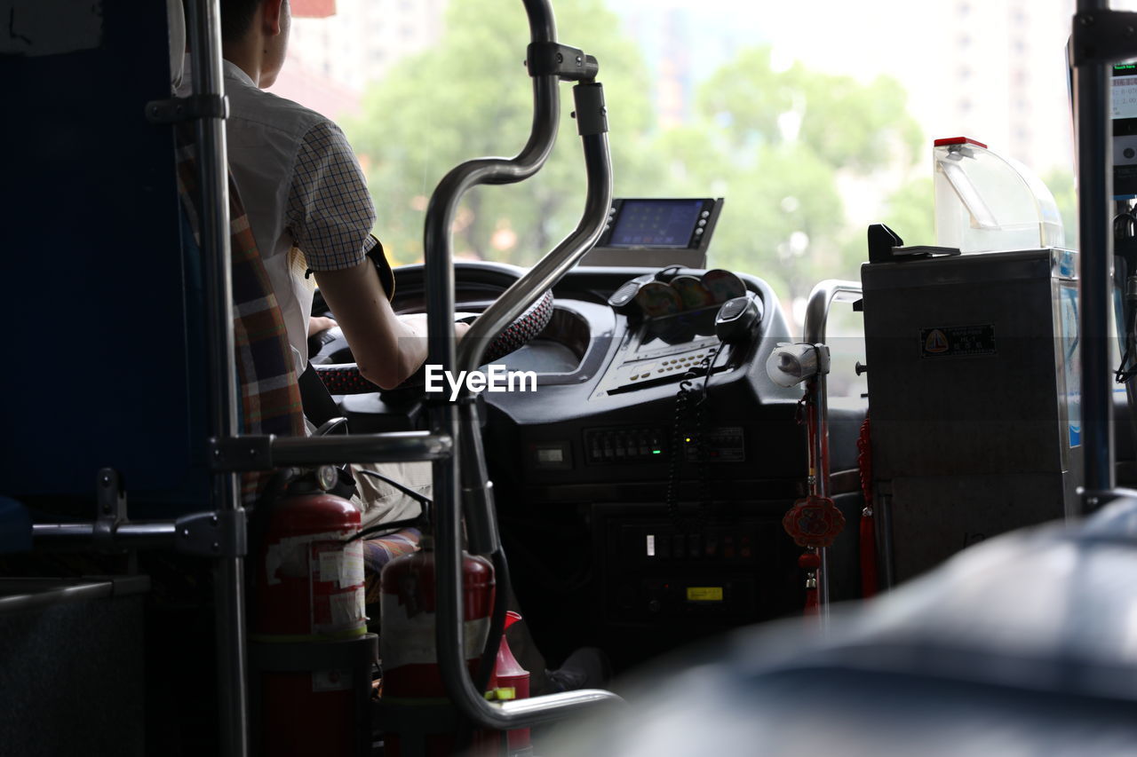 Cropped image of driver driving bus