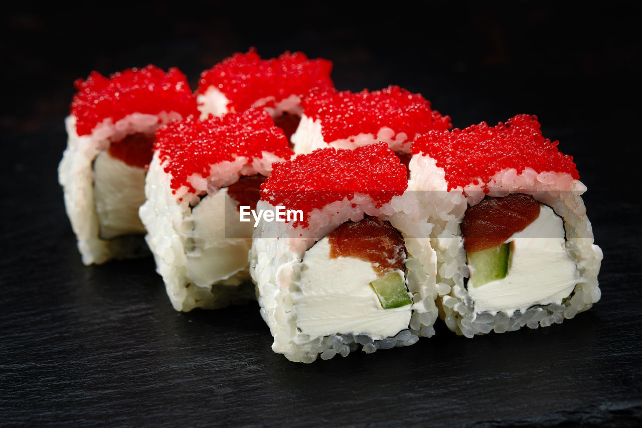 food and drink, food, healthy eating, freshness, black background, sushi, wellbeing, indoors, cuisine, dish, fruit, dessert, no people, red, produce, sweet food, japanese food, still life, studio shot, close-up, sweet, seafood, berry, asian food, flower, rice, strawberry