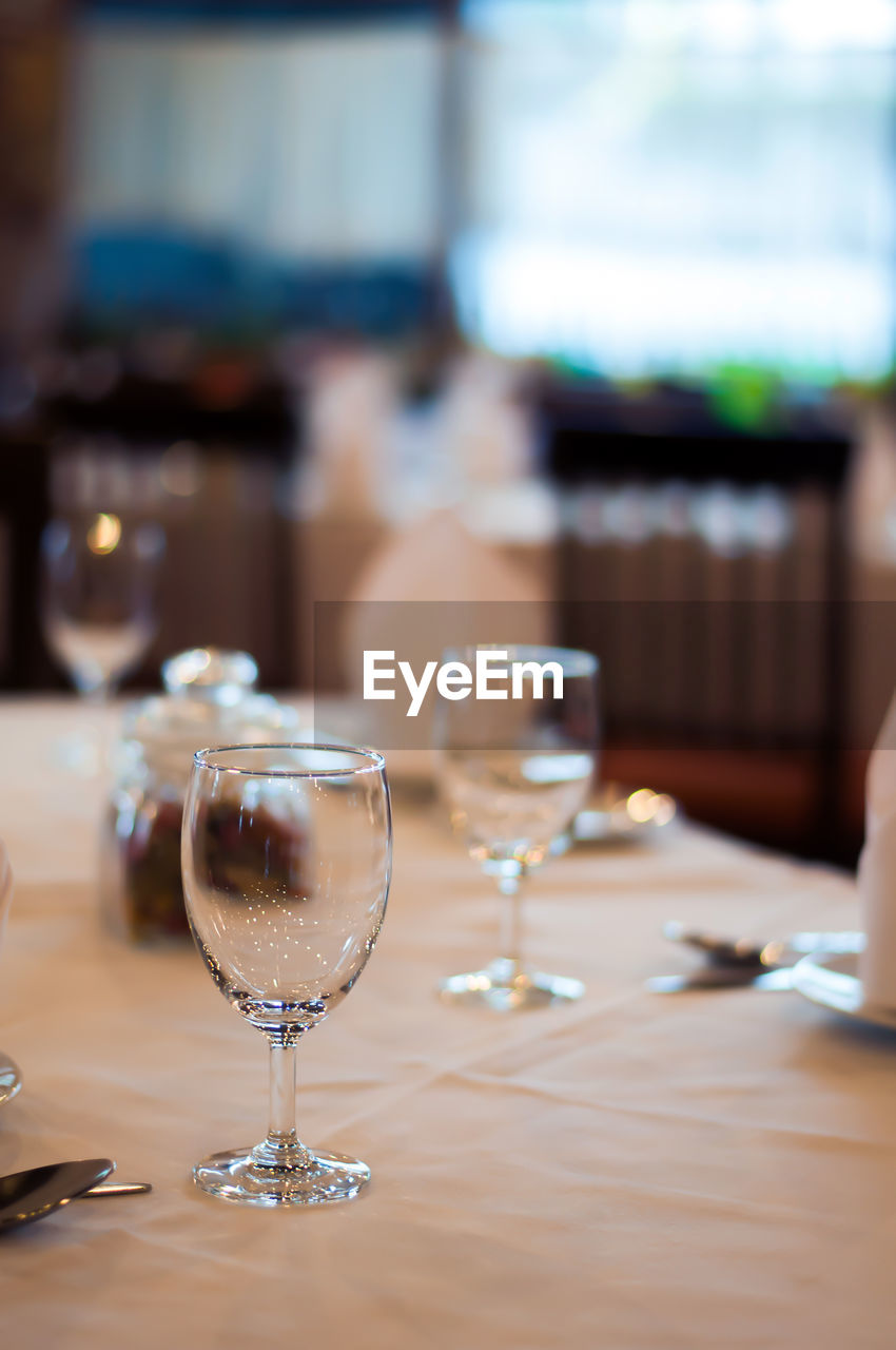 CLOSE-UP OF WINE GLASSES ON TABLE