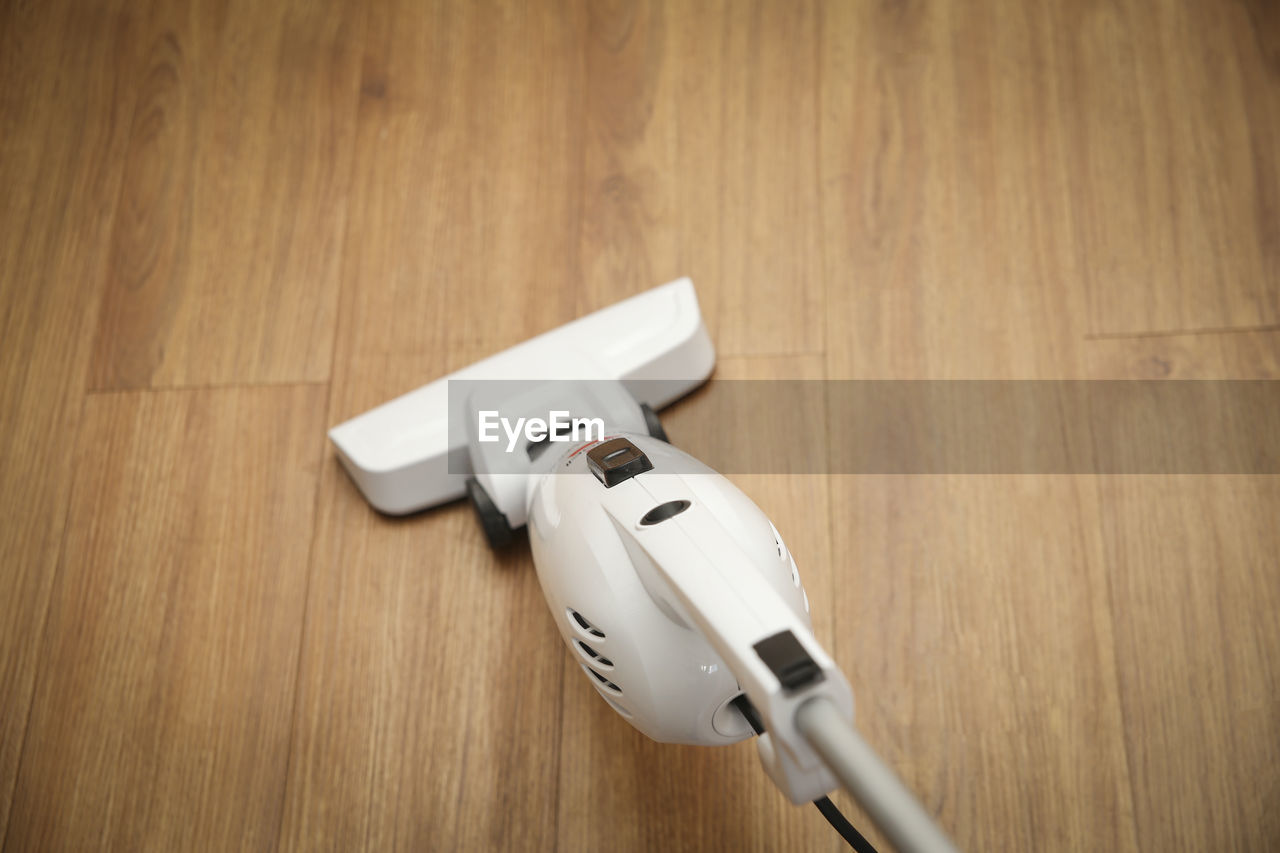 High angle view of vacuum cleaner on hardwood floor