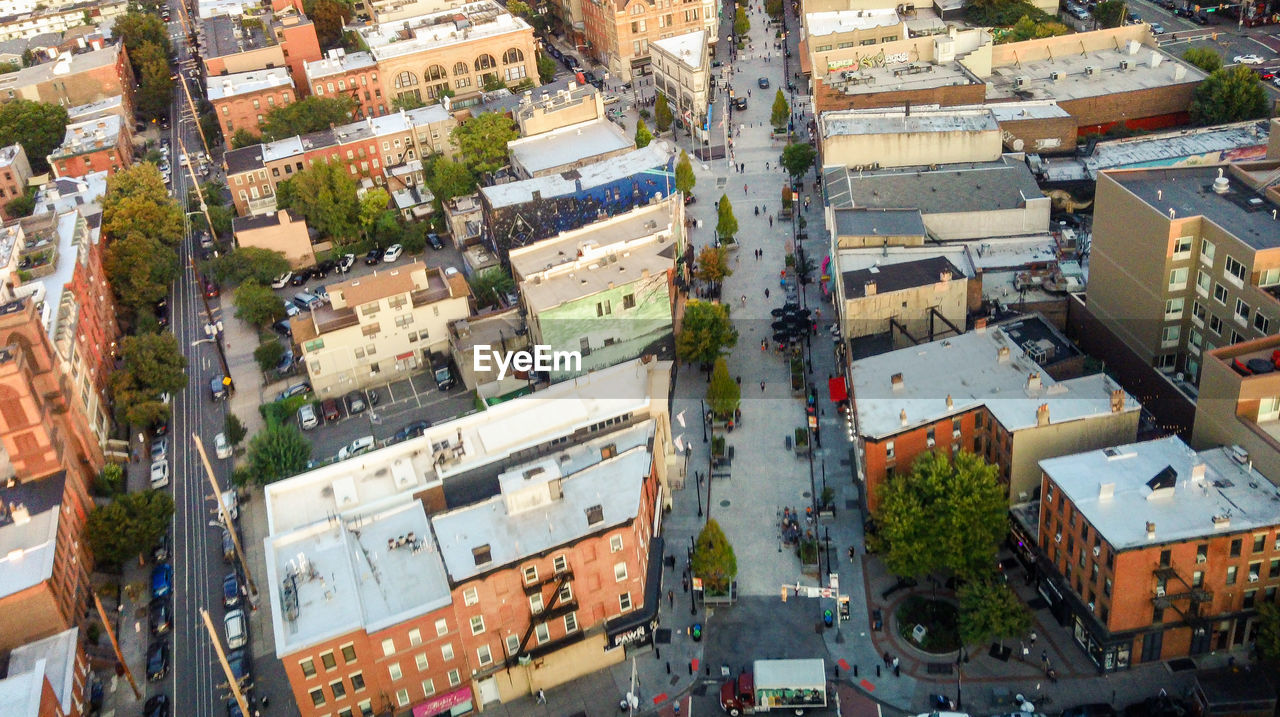 architecture, neighbourhood, city, building exterior, built structure, residential area, high angle view, aerial photography, bird's-eye view, building, town, suburb, urban area, cityscape, residential district, transportation, metropolitan area, street, aerial view, mode of transportation, downtown, roof, crowd, metropolis, city life, day, road, city street, nature, crowded, motor vehicle, car, outdoors, house, land vehicle, plant, community, travel destinations, tree, traffic, travel