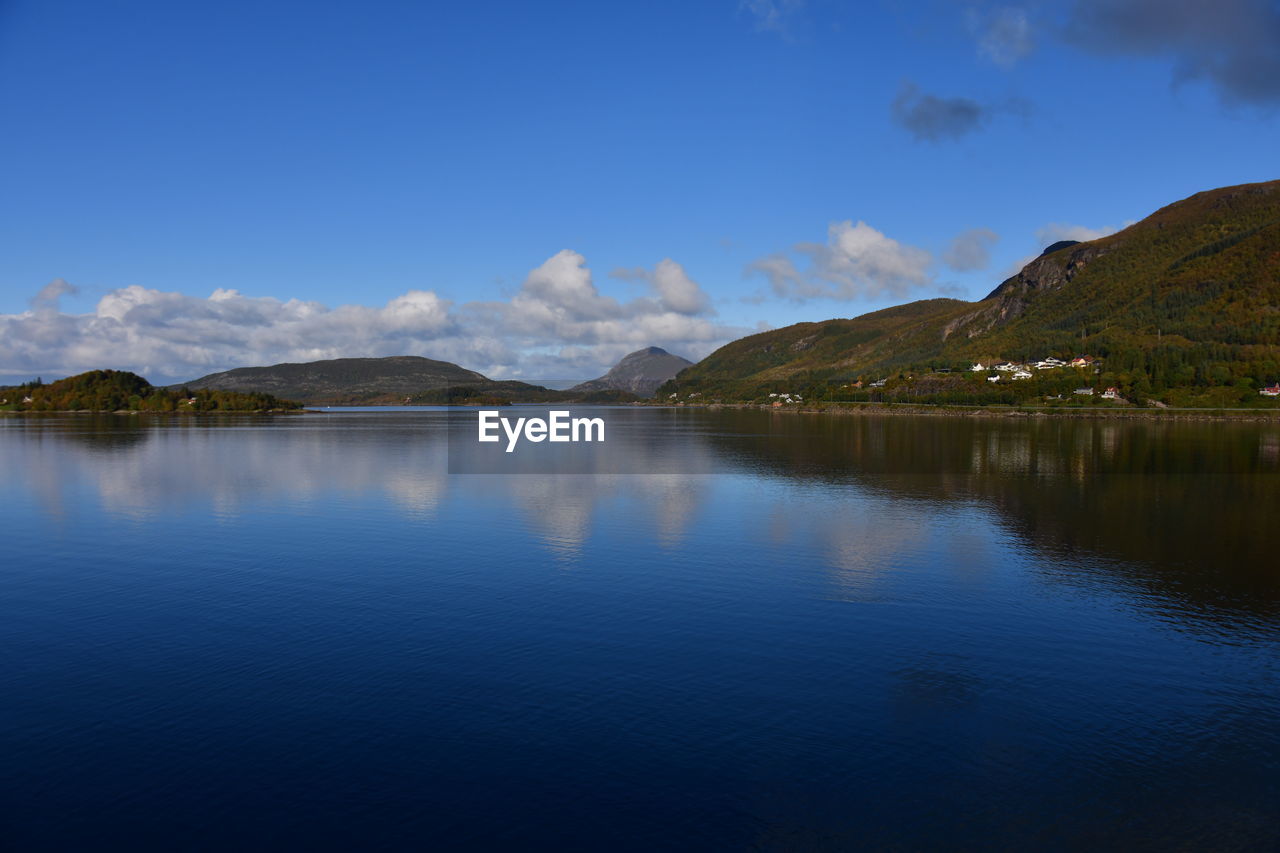 reflection, mountain, water, scenics - nature, sky, lake, beauty in nature, body of water, environment, landscape, mountain range, nature, reservoir, tranquility, tranquil scene, no people, cloud, blue, land, travel destinations, dusk, travel, morning, outdoors, idyllic, non-urban scene, tourism, highland, day, tree