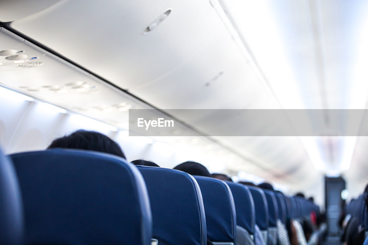 Rear view of man sitting in airplane