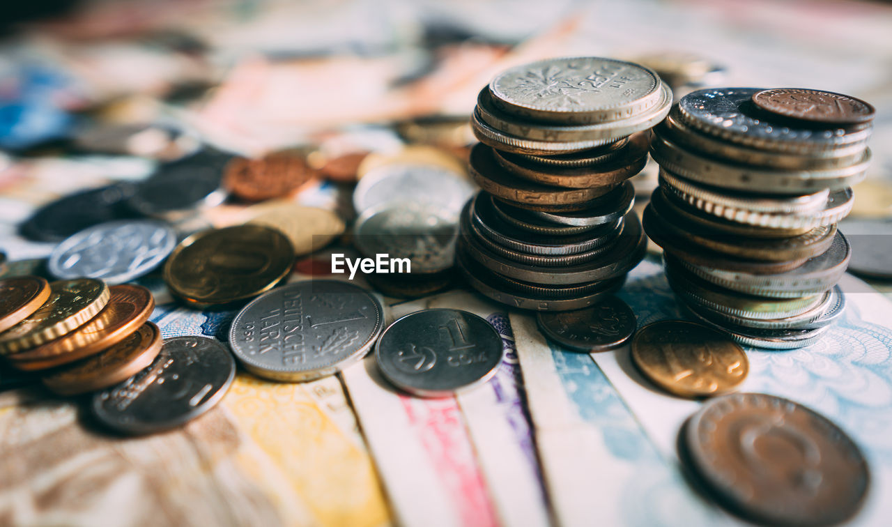 High angle view of coins and paper currency on table