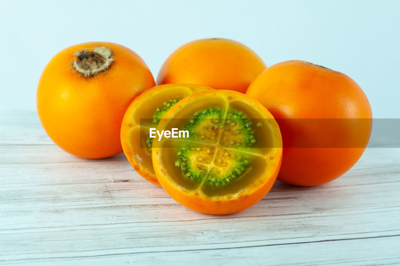 food and drink, food, healthy eating, wellbeing, freshness, fruit, orange color, plant, produce, cross section, wood, indoors, studio shot, no people, vegetable, yellow, slice, still life, tomato, citrus fruit, halved, group of objects, orange, vitamin, close-up