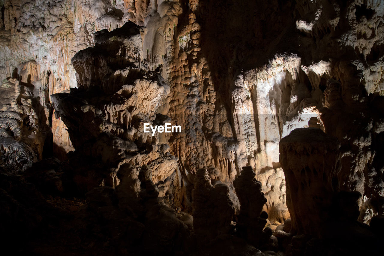 LOW ANGLE VIEW OF ROCK FORMATIONS AT CAVE