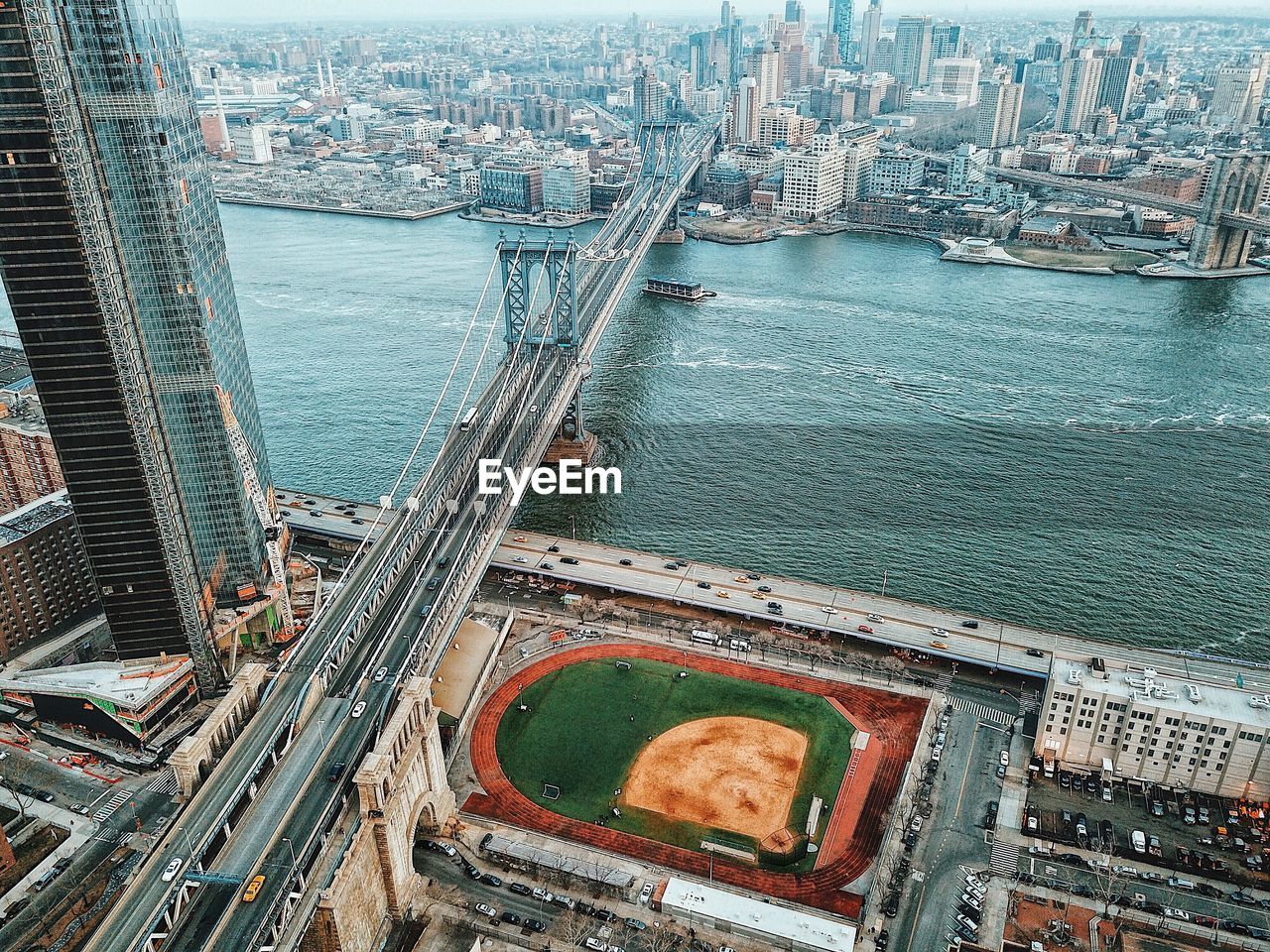 High angle view of bridge over river and buildings in city