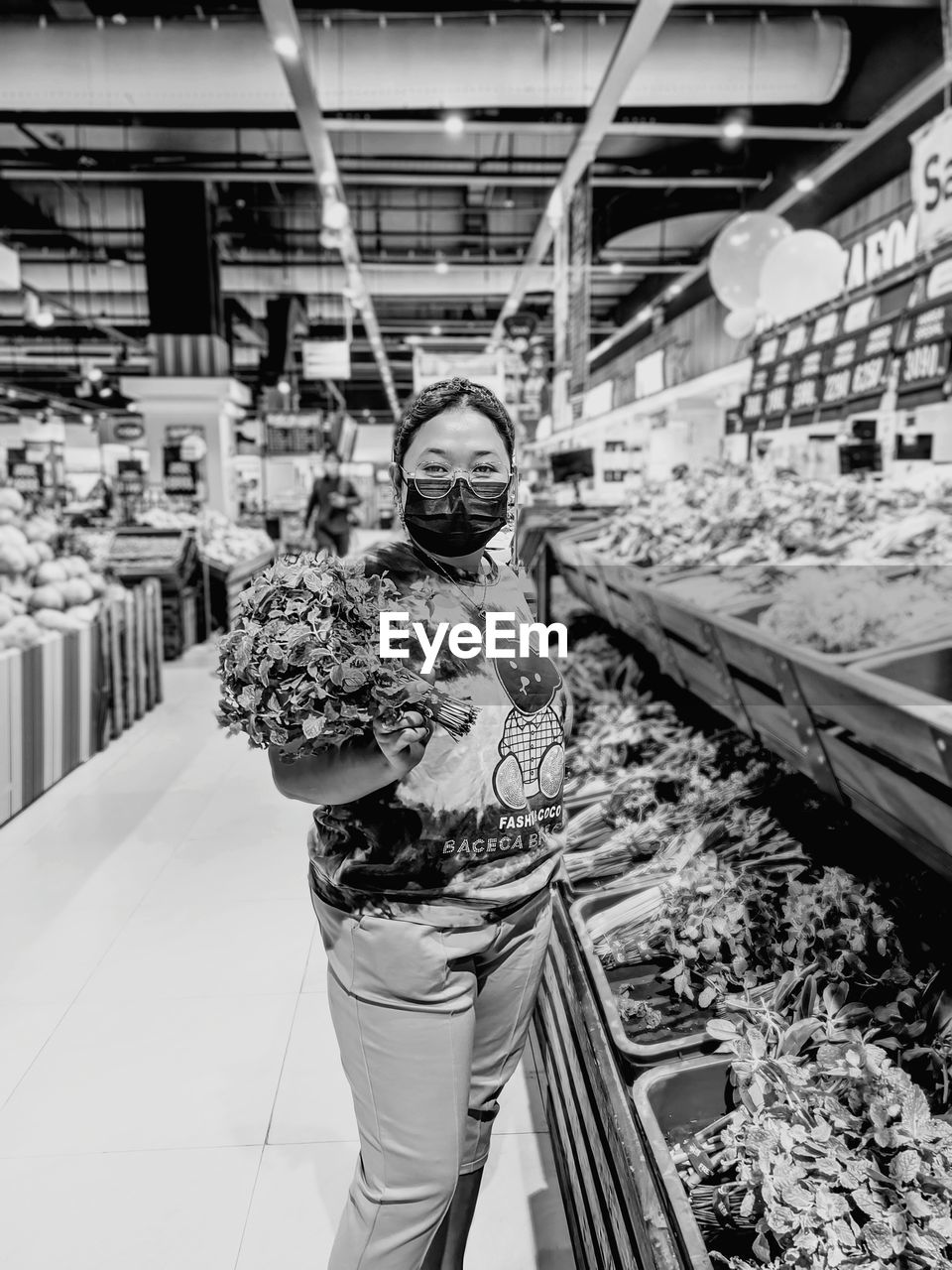 Portrait of woman wearing mask standing in market