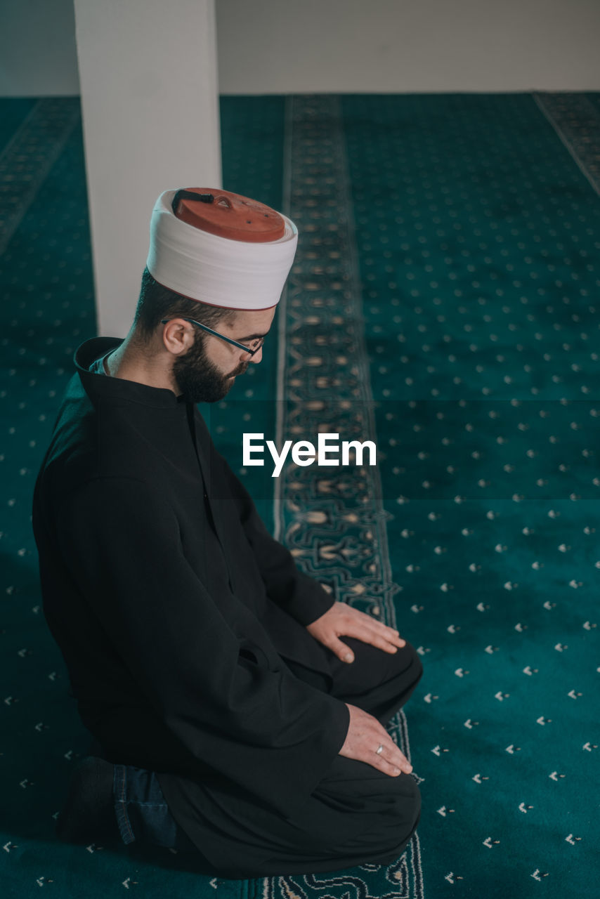 High angle view of man praying at mosque