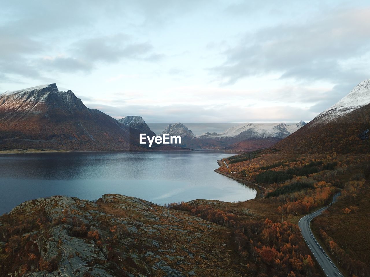 Aerial view of sea and mountains against sky