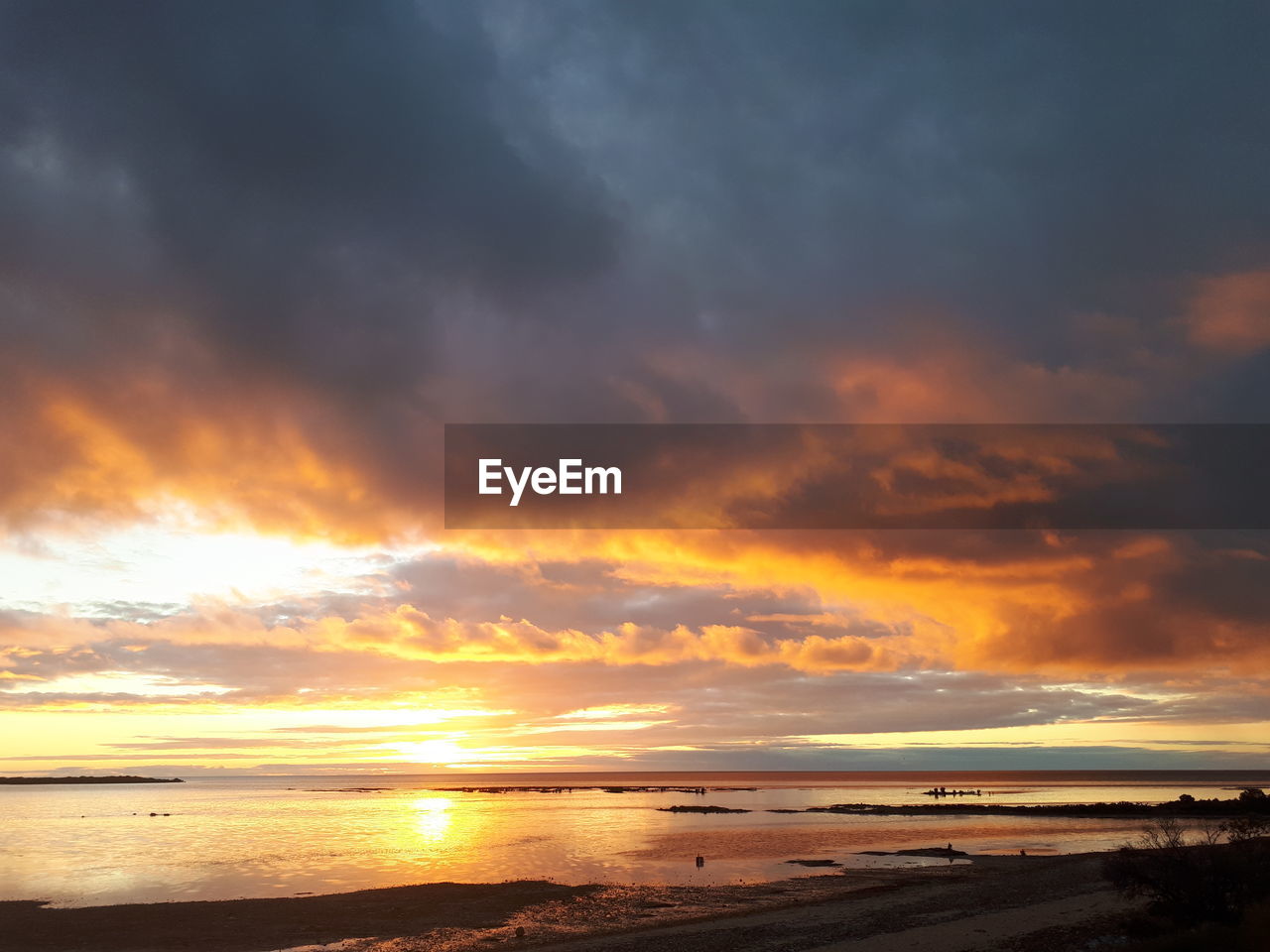 Scenic view of beach against sky during sunset