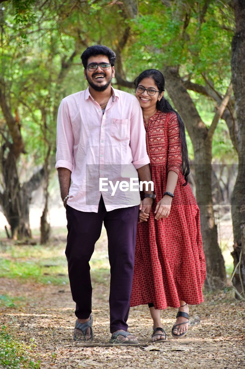 Full length of couple standing on field