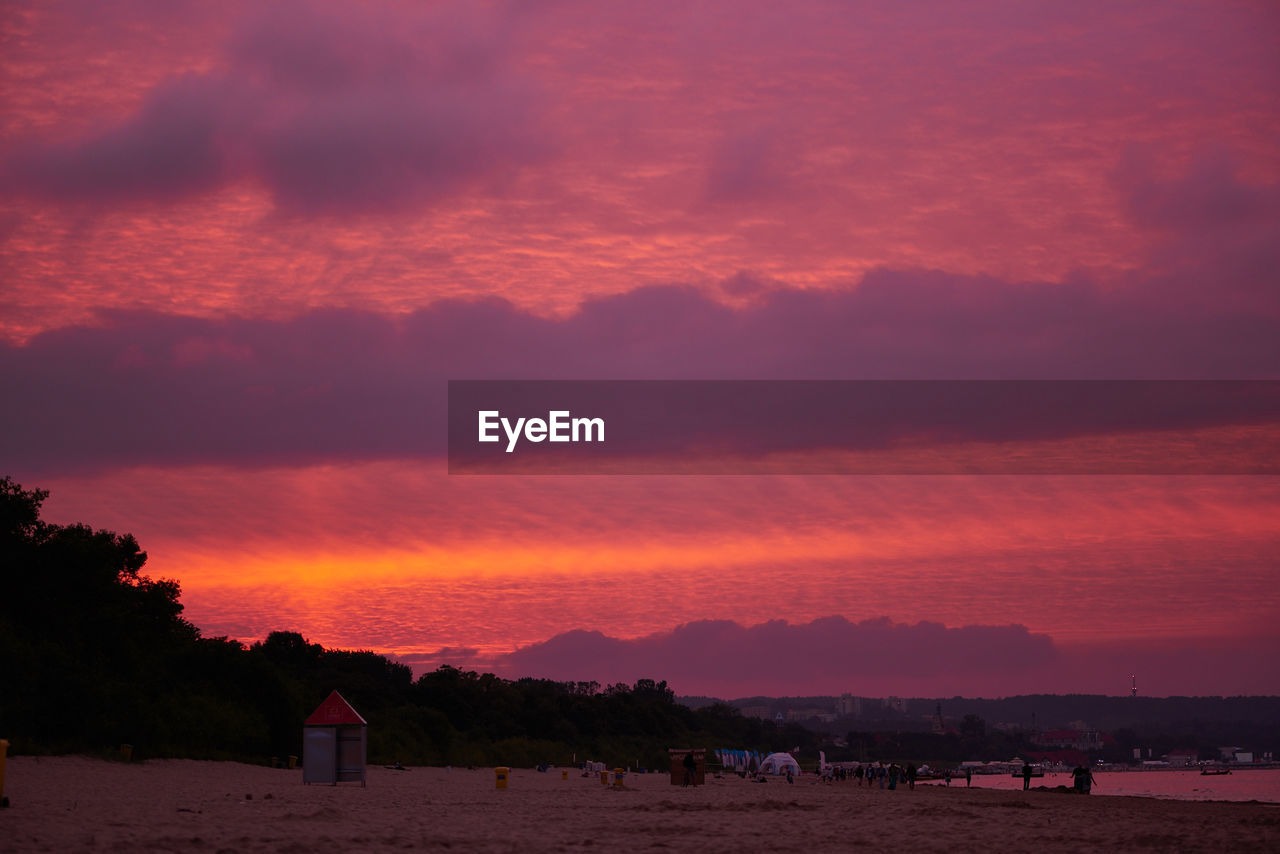 Scenic view of mountains against cloudy sky at sunset