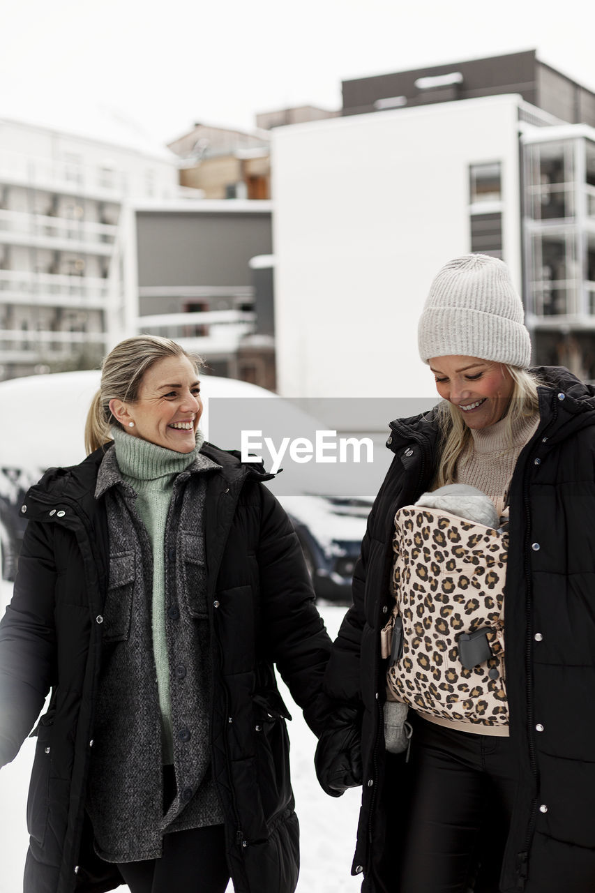 Female couple walking together at winter