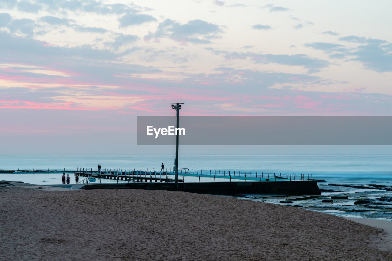 Scenic view of beach against sky during sunset