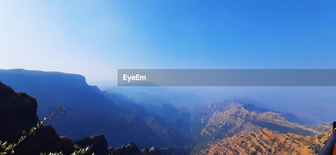 PANORAMIC SHOT OF MOUNTAINS AGAINST CLEAR BLUE SKY