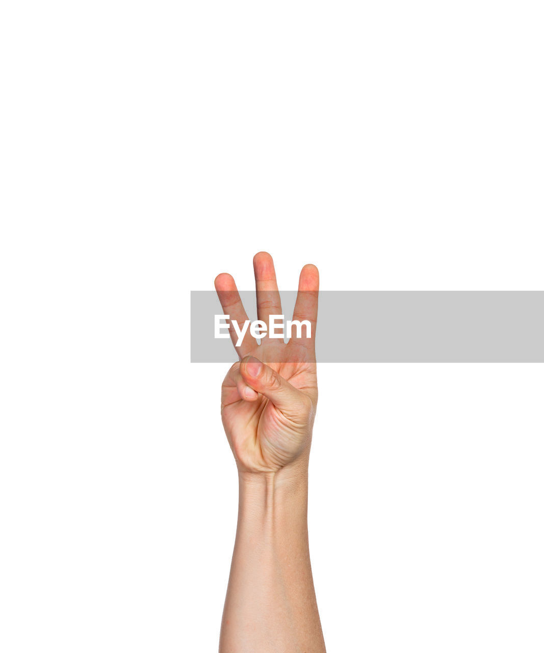 Cropped hand of person showing number 3 against white background