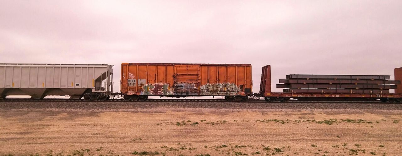 Freight train against sky