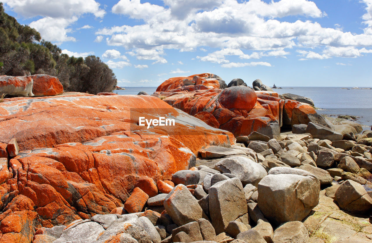 ROCKS ON SHORE AGAINST SKY