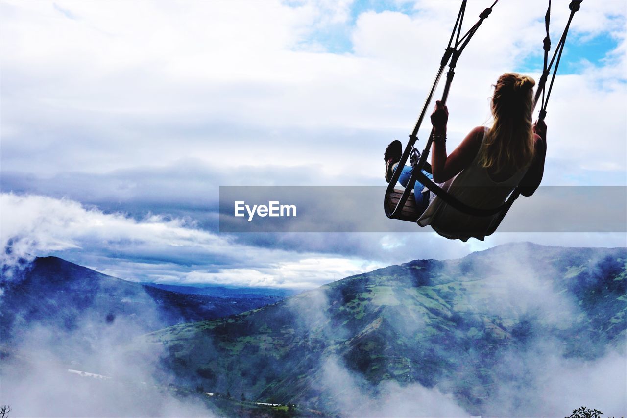 LOW ANGLE VIEW OF PERSON ON SWING