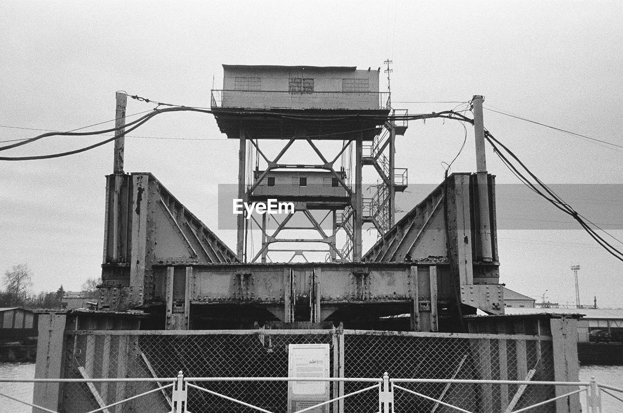 LOW ANGLE VIEW OF BRIDGE CABLES AGAINST SKY