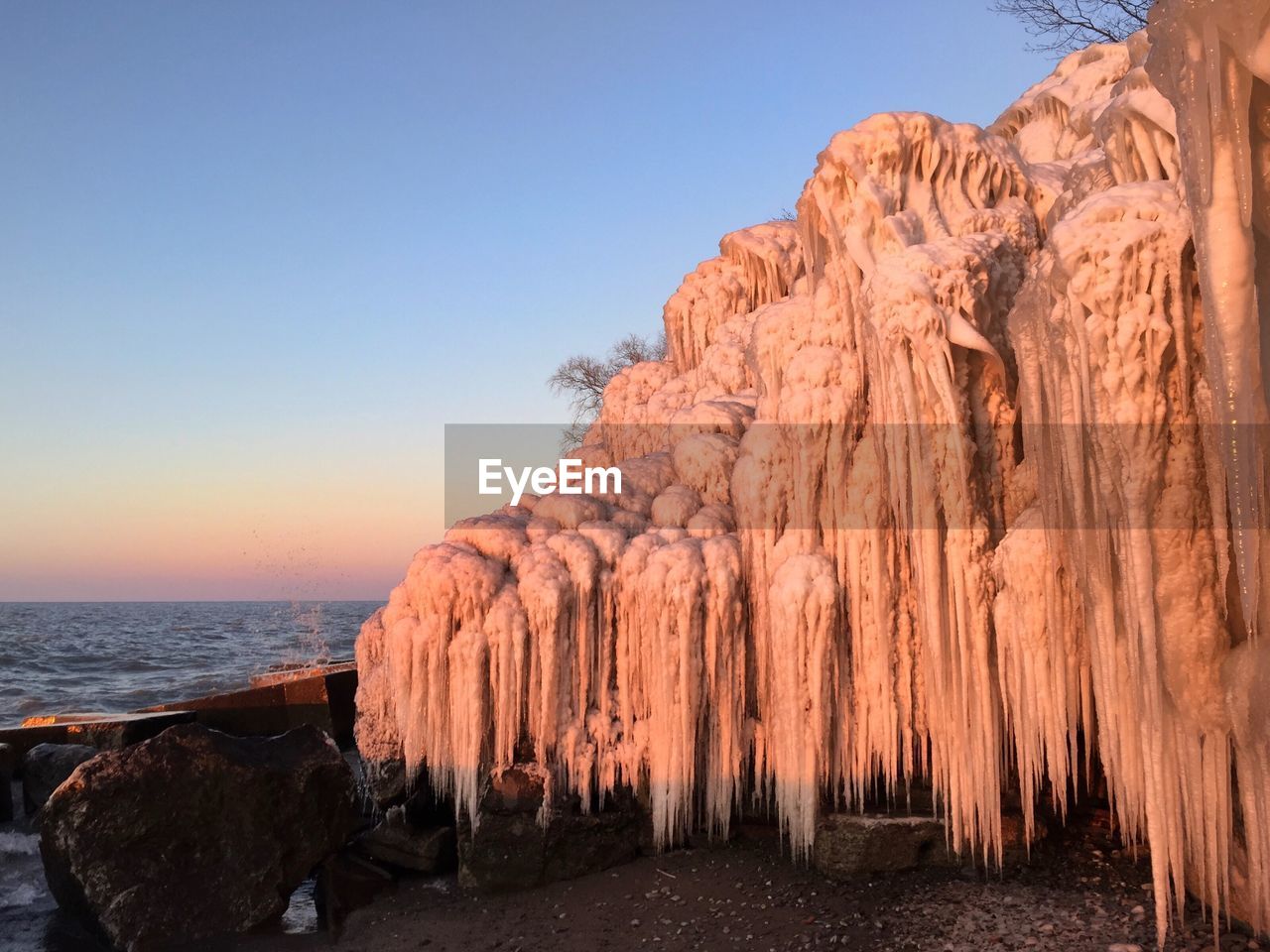 PANORAMIC VIEW OF ROCKS ON SEA AGAINST CLEAR SKY