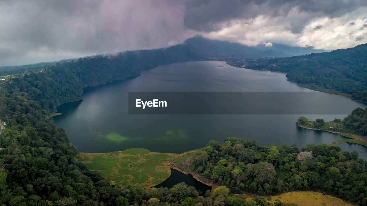 Scenic view of lake and mountains against sky