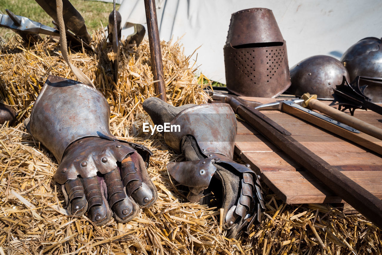 High angle view of medieval weapons on field