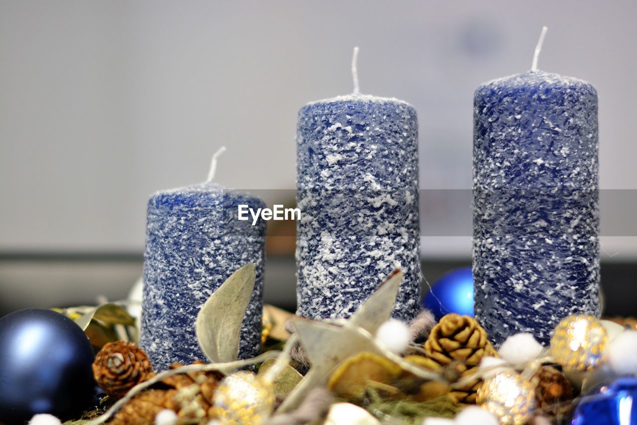 Close-up of candles by christmas decoration