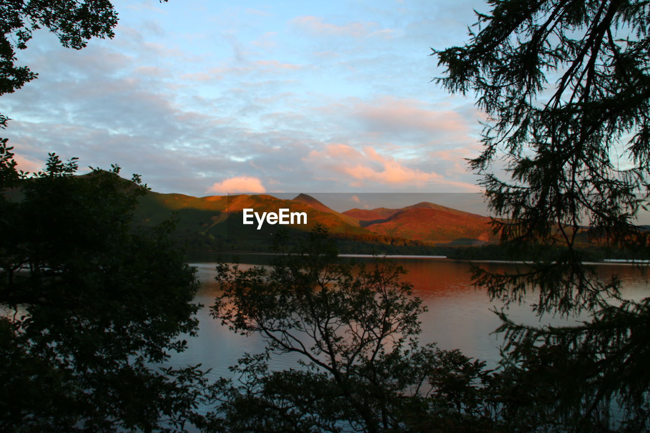 Scenic view of lake against cloudy sky