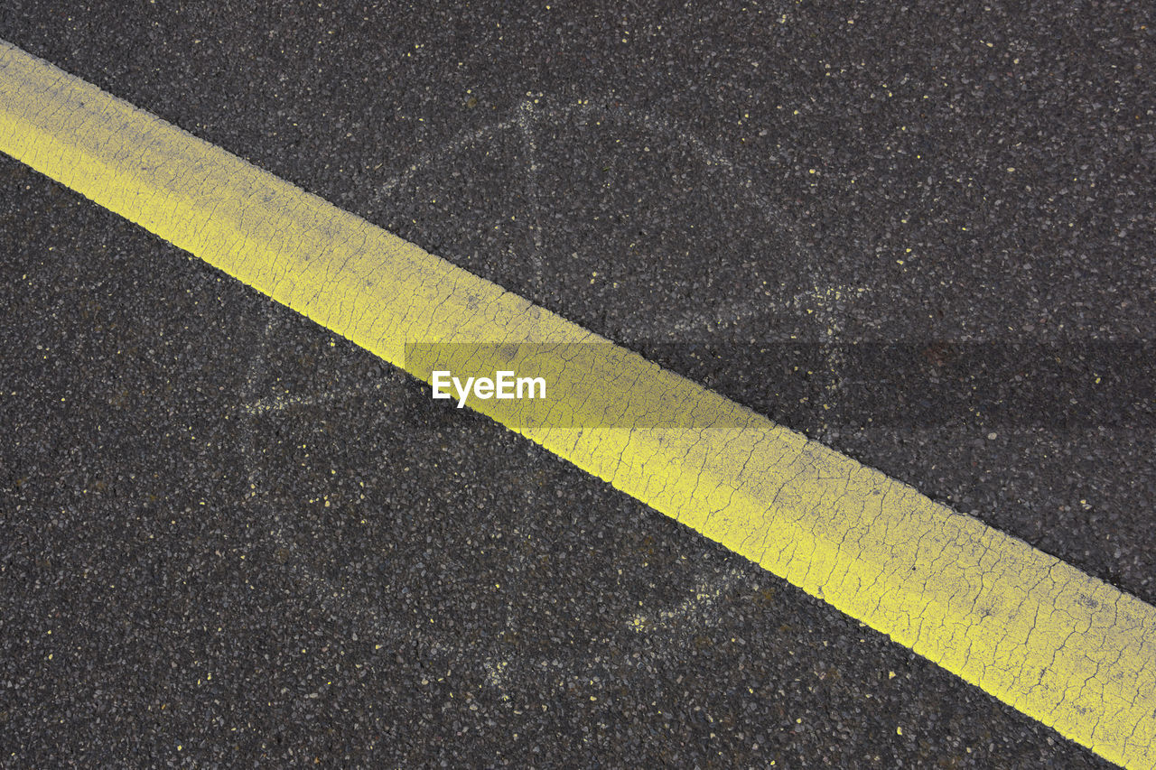 High angle view of yellow marking on road