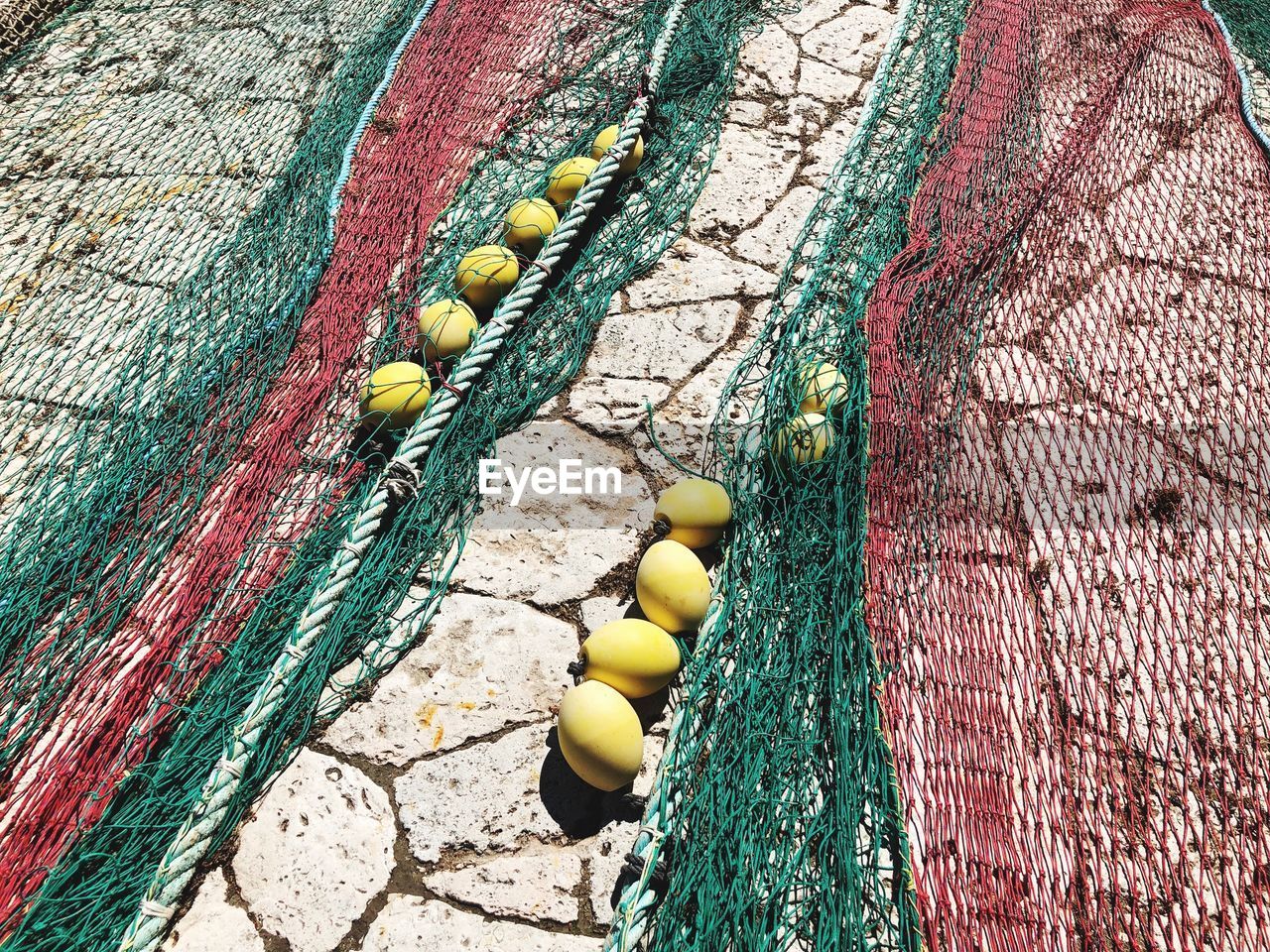 High angle view of fishing nets on street during sunny day