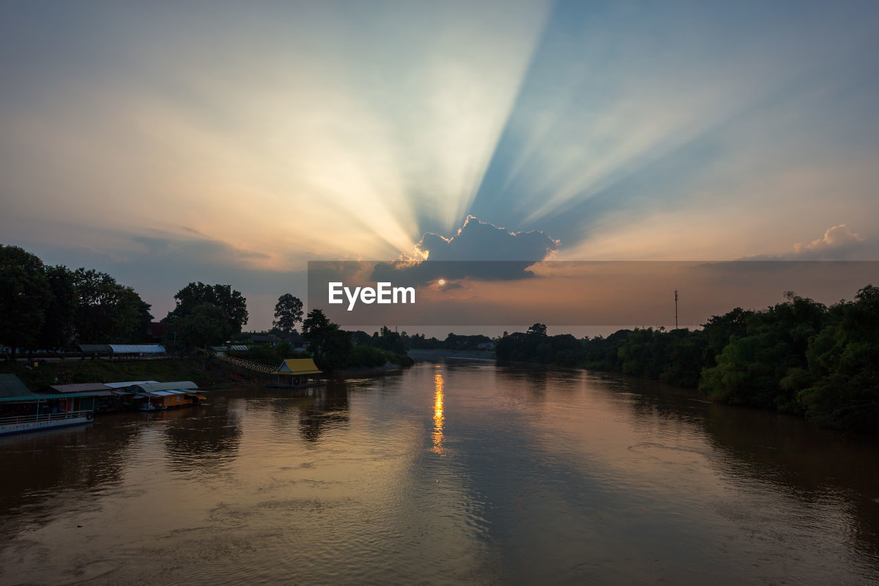 SCENIC VIEW OF RIVER BY TREES AGAINST SKY DURING SUNSET