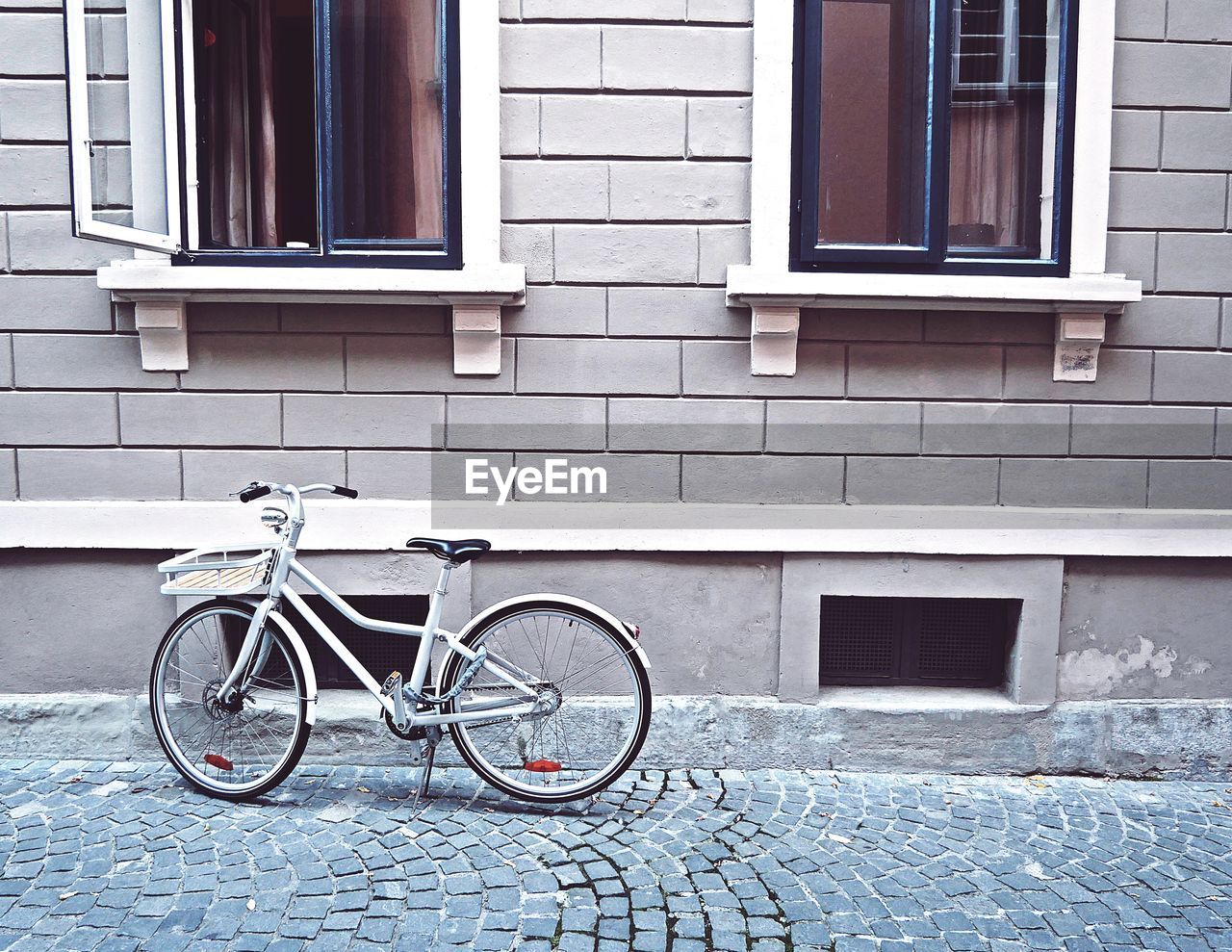 Bicycle parked on street against building