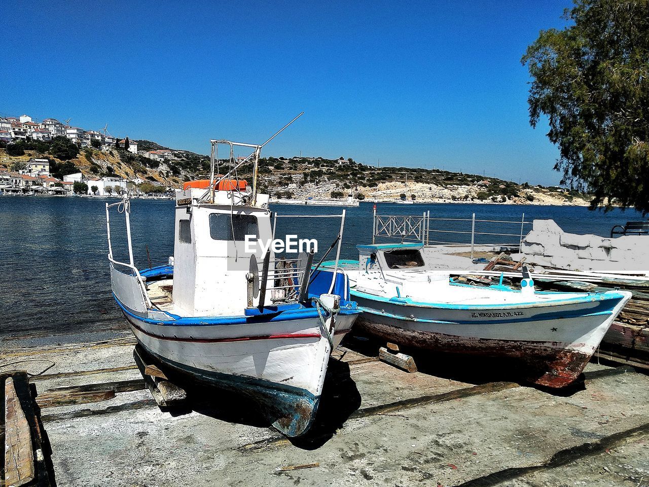 BOATS MOORED ON SEA AGAINST CLEAR SKY