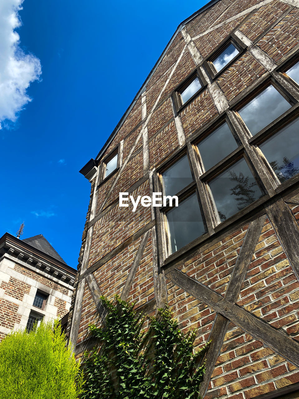 architecture, building exterior, built structure, building, sky, window, urban area, house, low angle view, nature, residential area, city, no people, facade, blue, residential district, neighbourhood, cloud, roof, day, outdoors, plant, landmark, brick, tower