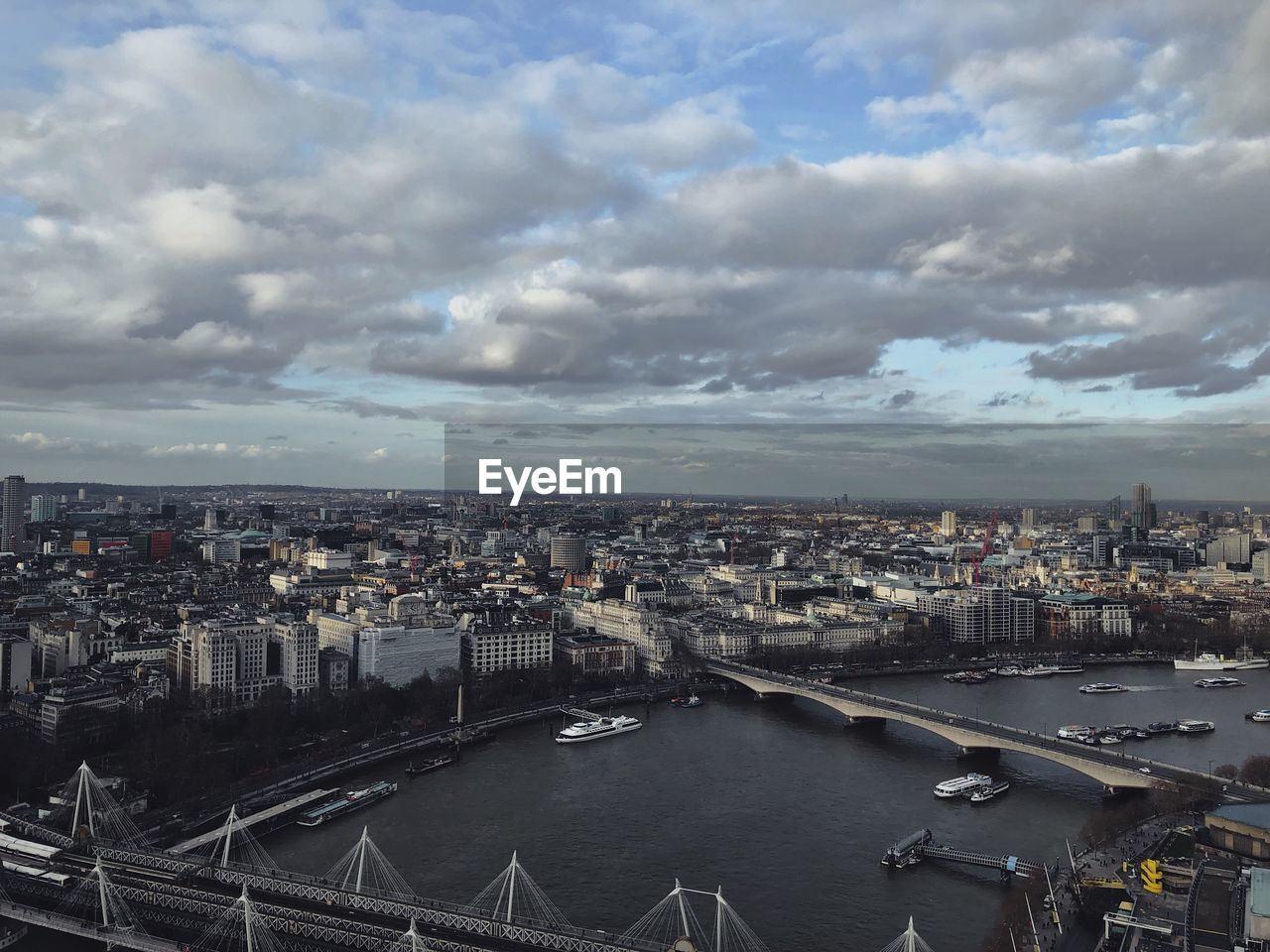 High angle view of river amidst buildings in city against sky