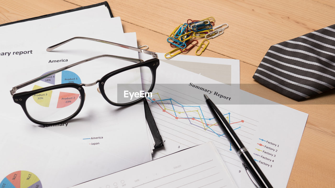 HIGH ANGLE VIEW OF EYEGLASSES ON PAPER