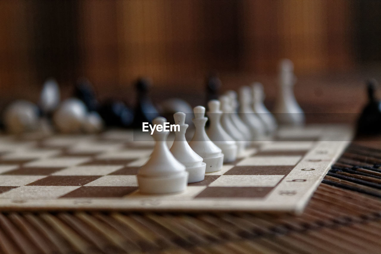 Close-up of chess pieces on place mat