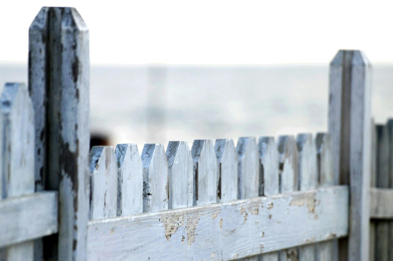 Close-up of wooden fence at beach