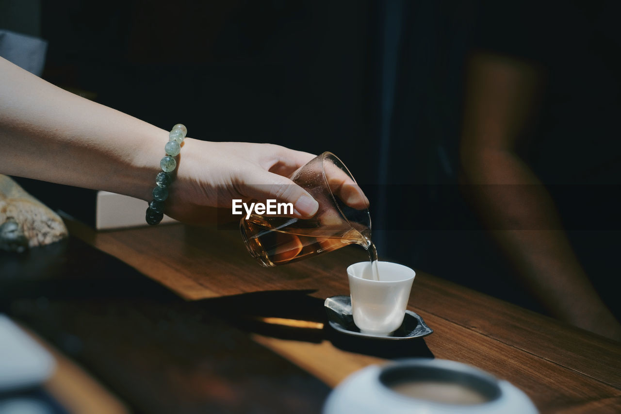 Woman holding coffee cup on table