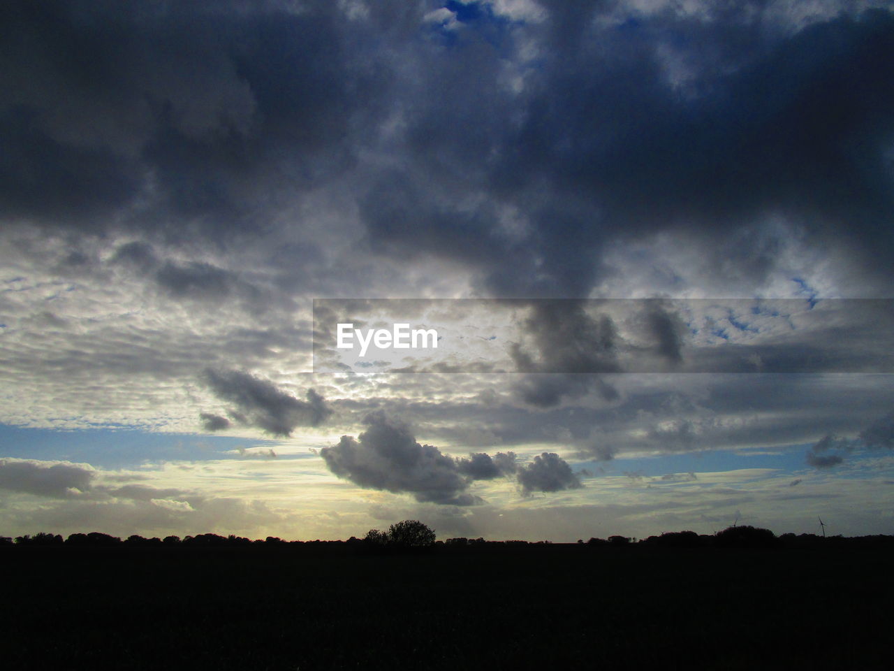 SILHOUETTE LANDSCAPE AGAINST DRAMATIC SKY